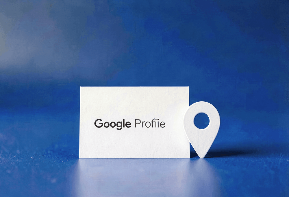 White business card with Google Profile label and location pin on blue studio background